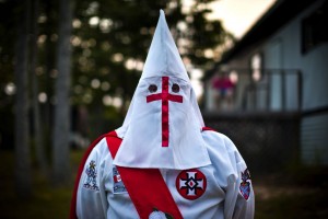 A member of the Rebel Brigade Knights of the Ku Klux Klan waits for the start of a cross lighting ceremony near Martinsville, Virginia, USA, July 2, 2011. (EPA/JIM LO SCALZO)