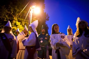 Members of the Knights of the Southern Cross of the Ku Klux Klan (KSCKKK), joined by members of other Virginia klan orders, wait to begin a cross lighting ceremony on private property near Powhatan, Virginia, USA, 28 May 2011. (EPA/JIM LO SCALZO)