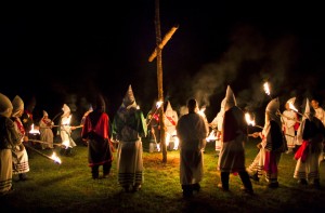 Members of the Knights of the Southern Cross of the Ku Klux Klan (KSCKKK), joined by members of other Virginia Klan orders, hold a cross lighting ceremony on private property near Powhatan, Virginia, USA, 28 May 2011. (EPA/JIM LO SCALZO)