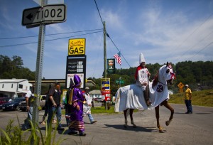 Members and supporters of Virgil's White Knights of the Ku Klux Klan, including Ernie Campbell (on horseback) and Imperial Wizard Gary Delp (purple robe), march through town during a Fourth of July weekend 'Mountain Treasures Festival' in Dungannon, Virginia, USA, 02 July 2011.(EPA/JIM LO SCALZO)