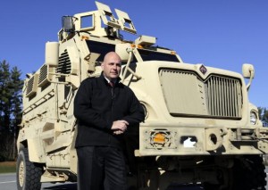 Warren County Under-sheriff Shawn Labouree stands next to the department's new mine resistance ambush protected vehicle, or MRAP in Queensbury, New York (Photo: Mike Groll / Associated Press)
